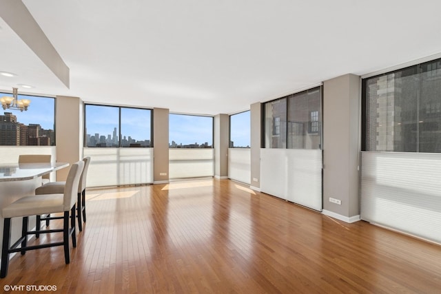345 W Fullerton Pkwy Unit 1006, Chicago, IL 60614 - living room with expansive windows, a notable chandelier, wood finished floors, and a city view