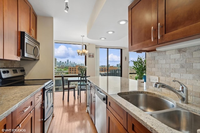 345 W Fullerton Pkwy Unit 1006, Chicago, IL 60614 - kitchen featuring a sink, brown cabinets, a city view, and stainless steel appliances