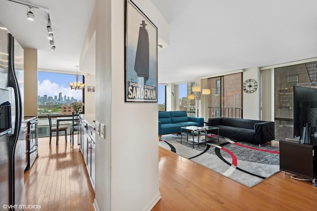 345 W Fullerton Pkwy Unit 1006, Chicago, IL 60614 - living room with a chandelier, rail lighting, a view of city, a wall of windows, and wood finished floors