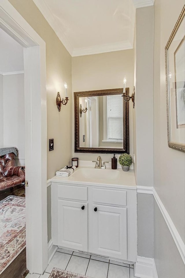 bathroom featuring baseboards, ornamental molding, vanity, and tile patterned flooring