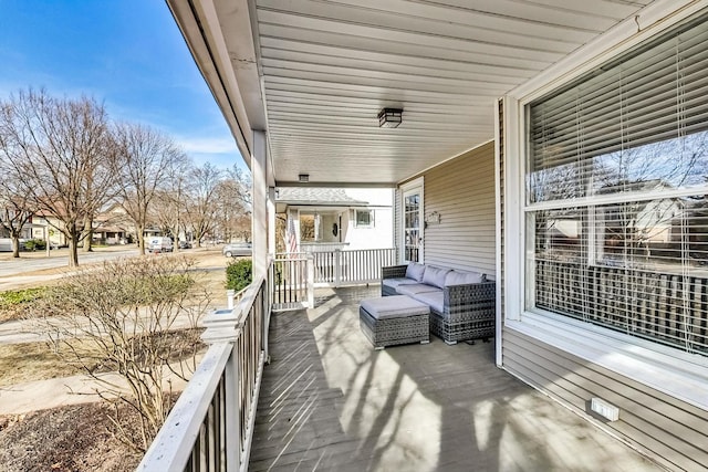 wooden deck featuring outdoor lounge area and covered porch