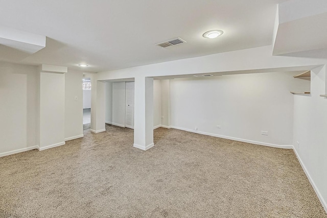 finished basement with visible vents, baseboards, and carpet