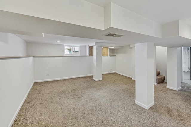 below grade area with visible vents, carpet floors, baseboards, and stairs