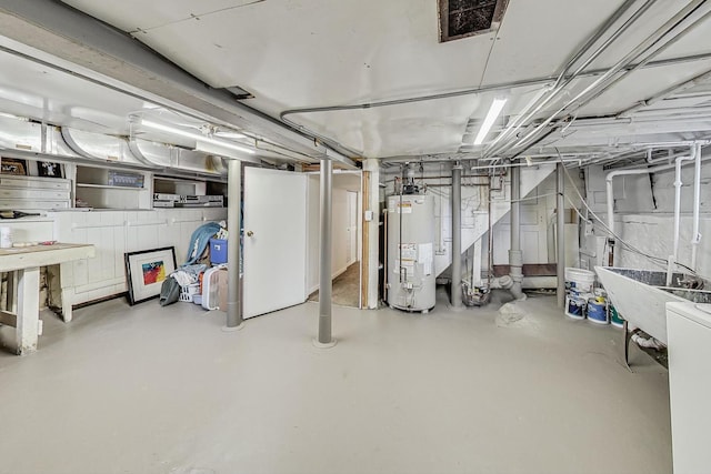 unfinished basement featuring gas water heater, visible vents, and a sink