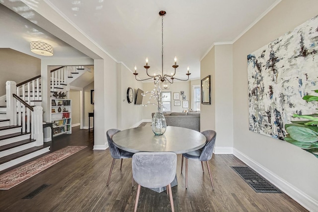 dining space featuring crown molding, stairway, wood finished floors, and visible vents