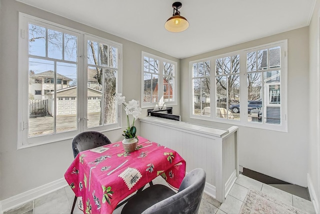 dining area with light tile patterned flooring and baseboards