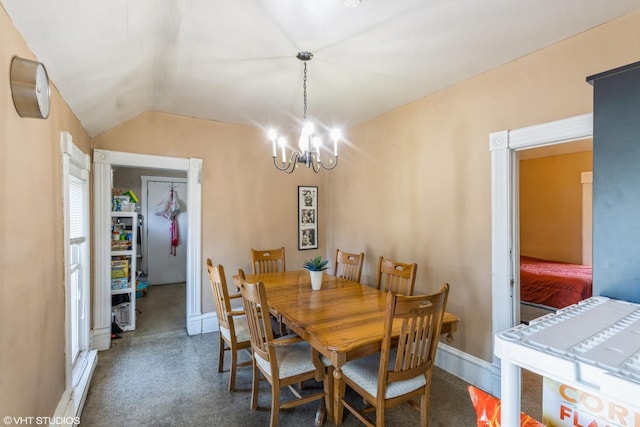 dining space featuring a chandelier, baseboards, and lofted ceiling