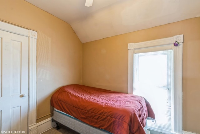 bedroom with multiple windows, a ceiling fan, and lofted ceiling