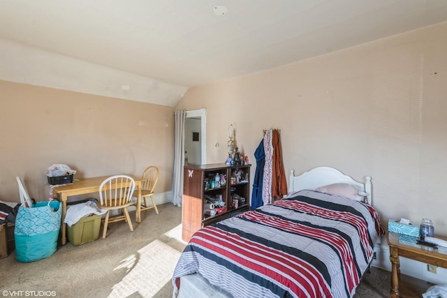 carpeted bedroom with lofted ceiling