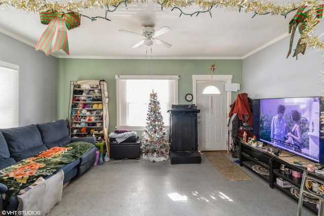 living room with a ceiling fan and ornamental molding