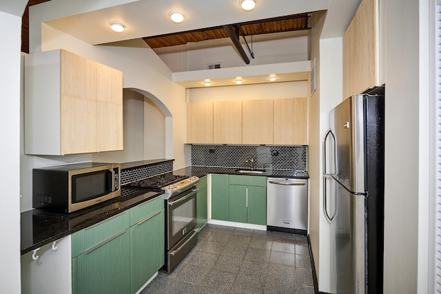 kitchen featuring visible vents, granite finish floor, a sink, appliances with stainless steel finishes, and backsplash