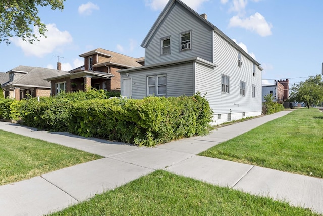 view of front of property with a chimney and a front lawn