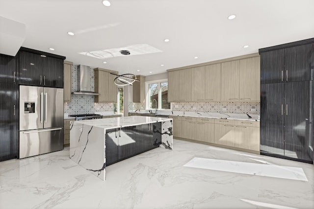 kitchen featuring wall chimney range hood, stainless steel fridge with ice dispenser, modern cabinets, and backsplash