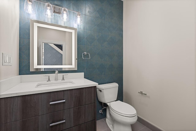 bathroom with vanity, tile patterned flooring, and toilet