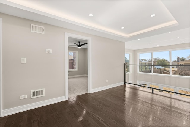 spare room with visible vents, recessed lighting, baseboards, and wood finished floors