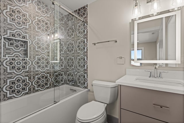 bathroom with toilet, shower / bath combination with glass door, and vanity