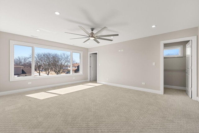 interior space with baseboards, a ceiling fan, recessed lighting, and a wealth of natural light