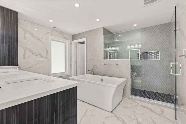 full bathroom featuring visible vents, marble finish floor, recessed lighting, a soaking tub, and a stall shower