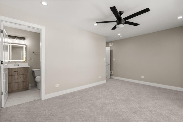 unfurnished bedroom featuring marble finish floor, baseboards, recessed lighting, connected bathroom, and a ceiling fan