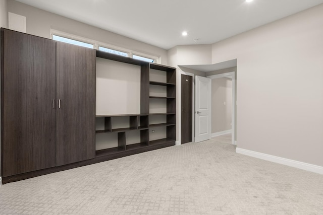 unfurnished bedroom with recessed lighting, baseboards, and light colored carpet