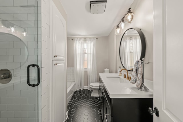 bathroom with vanity, a bathing tub, tile patterned flooring, toilet, and a shower with door