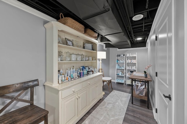 bar featuring dark wood-style floors and baseboards