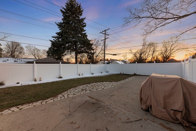 view of patio with grilling area and a fenced backyard