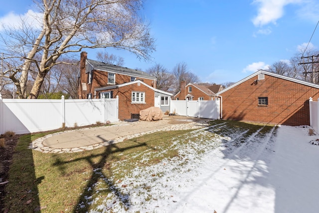 view of yard with a fenced backyard and a gate