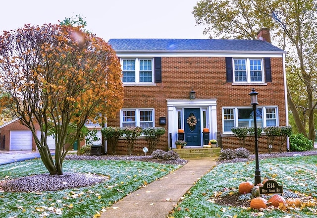 colonial house with brick siding and a chimney
