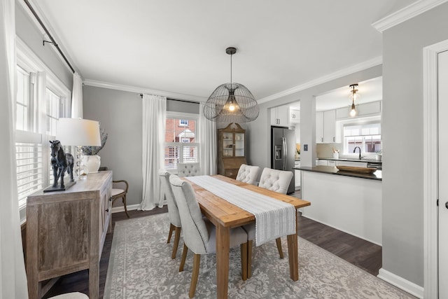 dining area featuring crown molding, dark wood-style floors, and baseboards
