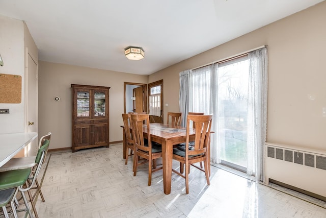 dining room with radiator heating unit and baseboards