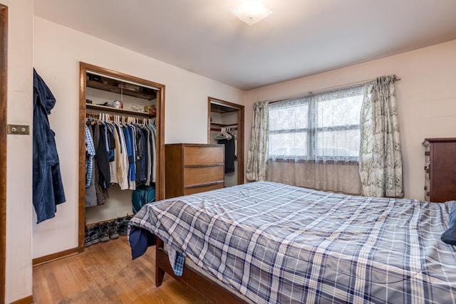 bedroom featuring baseboards and wood finished floors