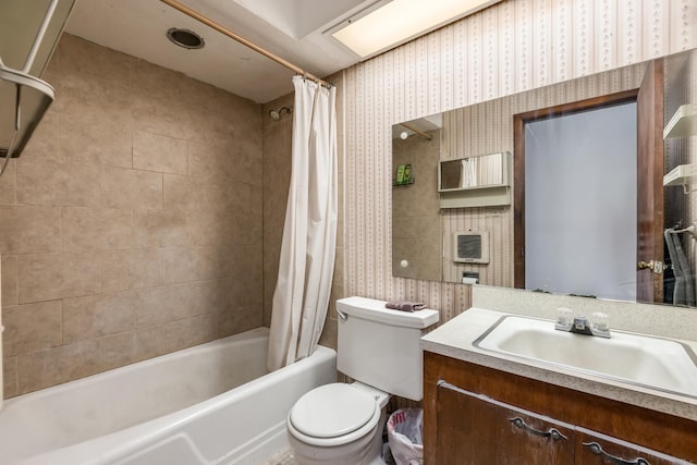 bathroom with toilet, vanity, wallpapered walls, and shower / bath combo with shower curtain