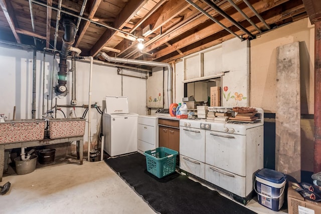 unfinished basement featuring washer and dryer and a sink