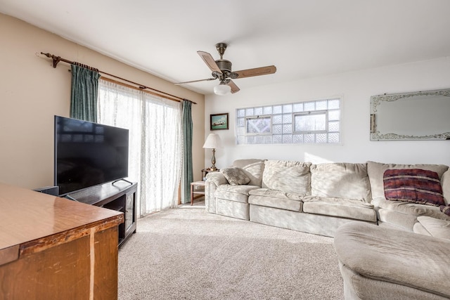 living area featuring a ceiling fan and carpet floors