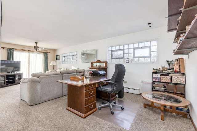 office area with a baseboard heating unit, light carpet, and a ceiling fan