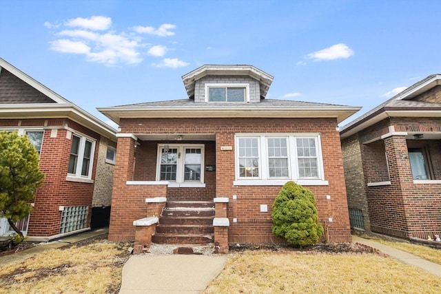 bungalow-style home featuring brick siding