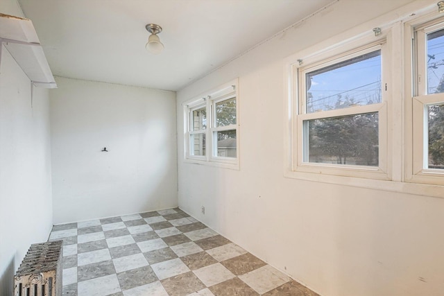 unfurnished room featuring light floors