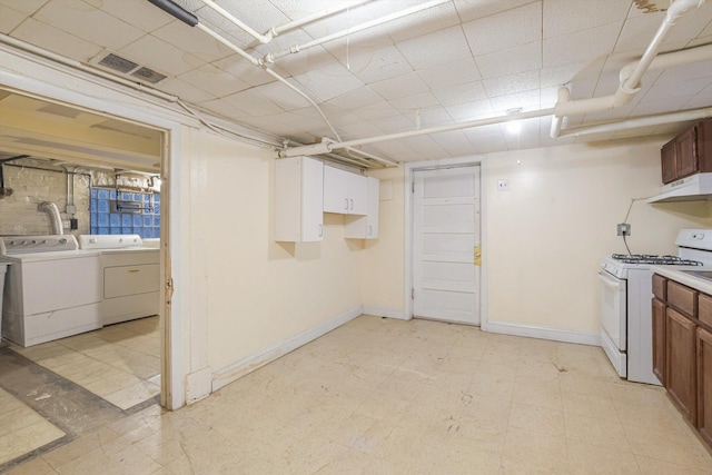 unfinished basement with washer and dryer, visible vents, baseboards, and light floors