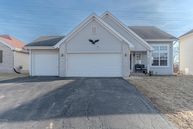 ranch-style home featuring brick siding, driveway, an attached garage, and a shingled roof