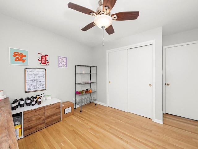 bedroom with a closet, a ceiling fan, and light wood-style floors