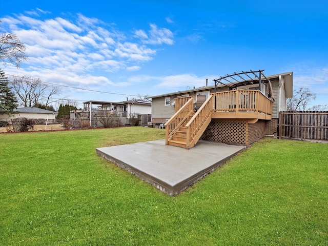 rear view of property with a patio, stairway, fence, a deck, and a lawn