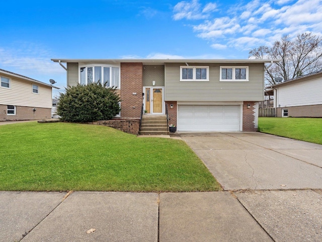 split foyer home with a front lawn, brick siding, an attached garage, and driveway