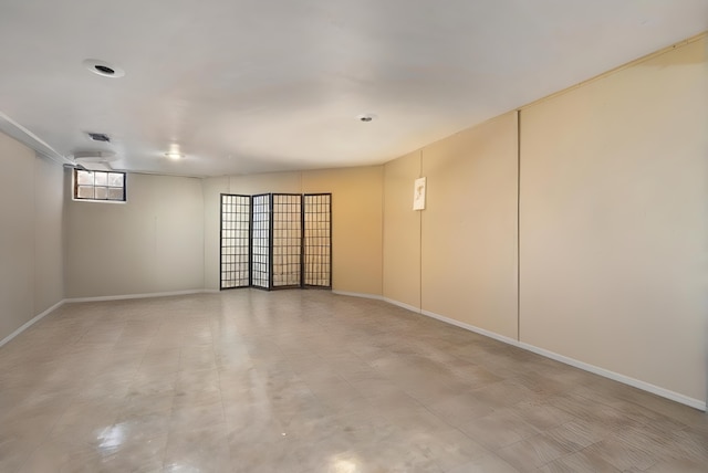 spare room featuring visible vents and baseboards