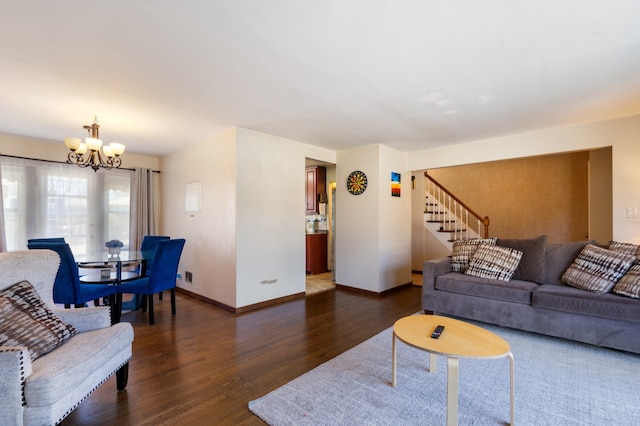 living area with baseboards, stairs, an inviting chandelier, and wood finished floors