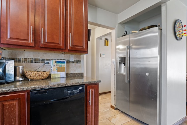 kitchen with light tile patterned floors, dark stone counters, stainless steel fridge with ice dispenser, dishwasher, and tasteful backsplash