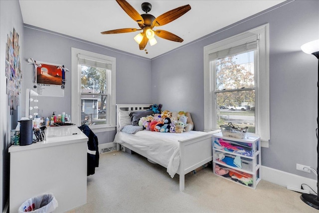 bedroom with baseboards, multiple windows, and carpet flooring