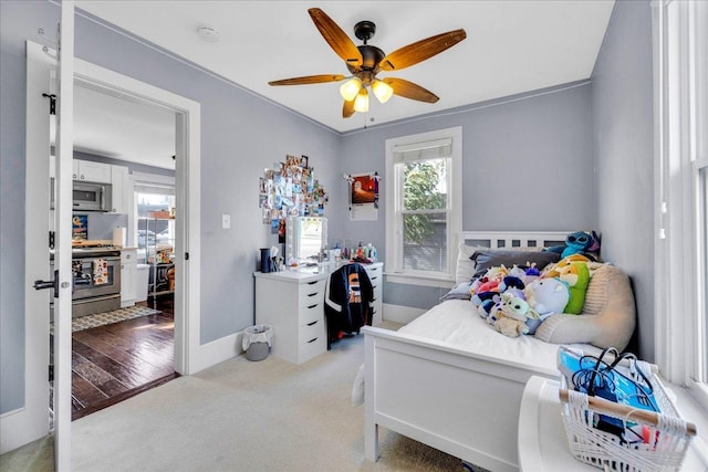 bedroom featuring carpet flooring, multiple windows, a ceiling fan, and baseboards