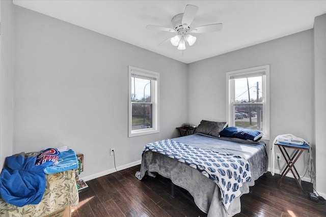 bedroom with ceiling fan, baseboards, and wood-type flooring