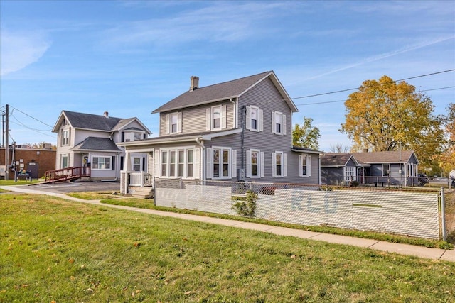 view of front of property with a front yard and fence